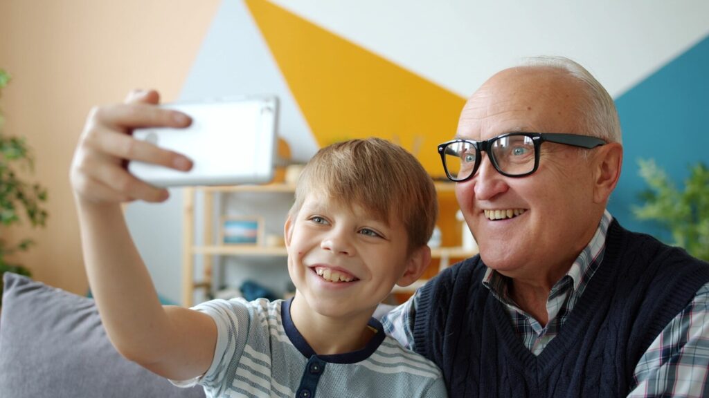 Grandfather and grandson taking a selfie together